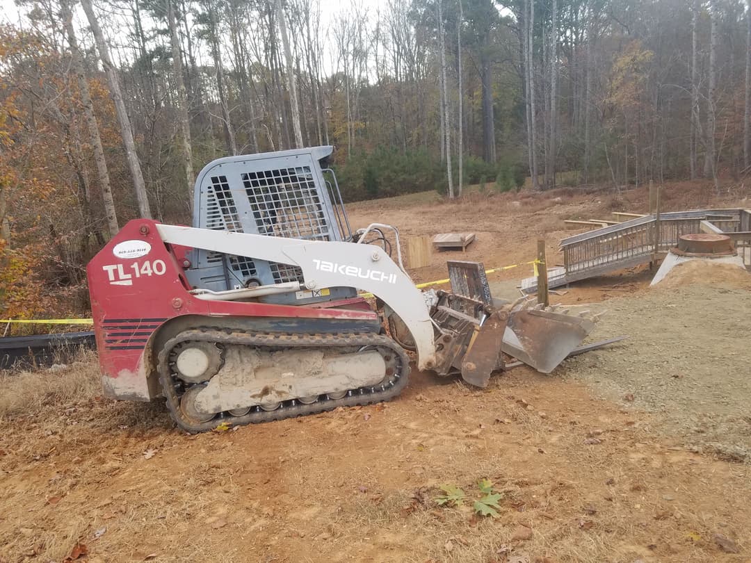 This was the first time I ever took my granddaddy’s TL-140 off the farm myself. That machine leveled the ground, spread rock, and helped set those decks in place. I remember sitting in that cab thinking, ‘Granddaddy would be proud.