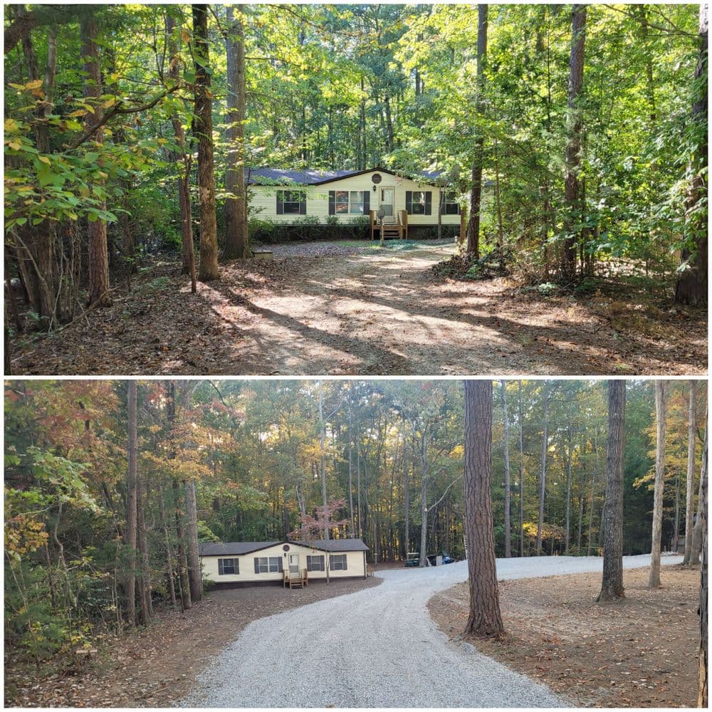 Cozy home nestled in woods, surrounded by trees and a gravel driveway, ideal for nature lovers.