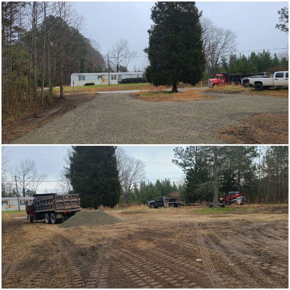 Construction site showing gravel installation with trucks and trees in a clearing area.